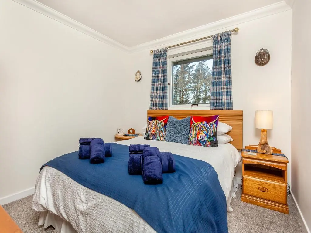 a bedroom with two beds and a window at Rock Folly in Inverness