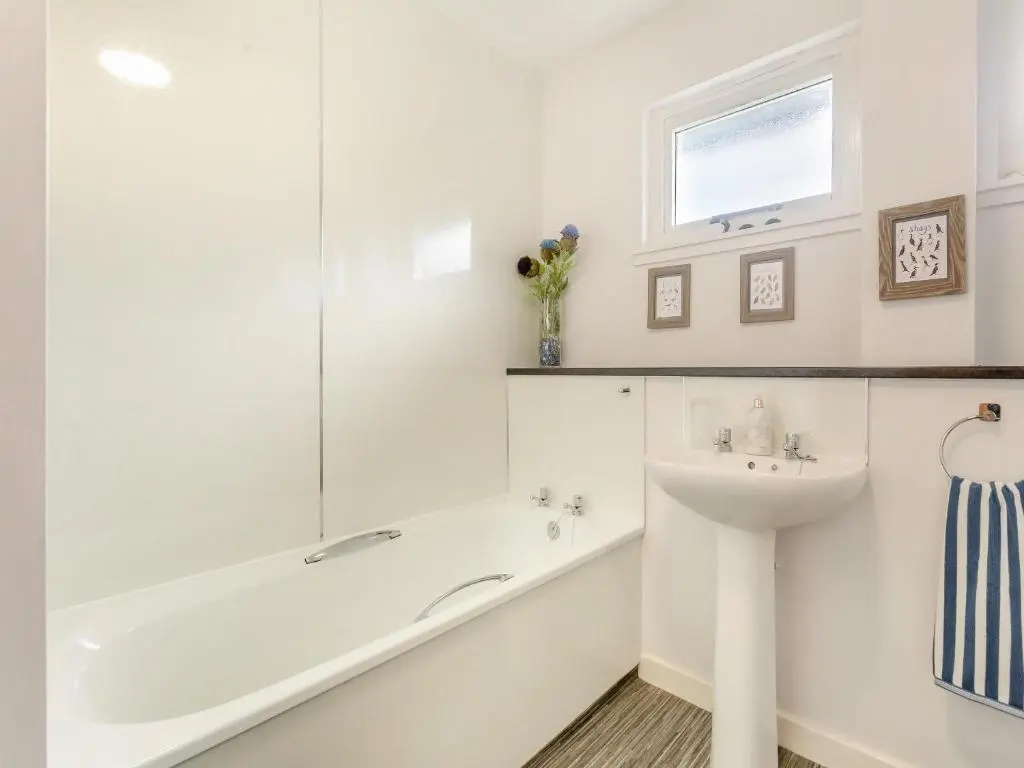 a white bathroom with a tub and a sink at Rock Folly in Inverness