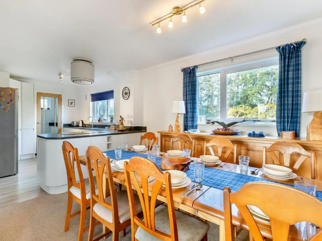 a kitchen and dining room with a table and chairs at Rock Folly in Inverness