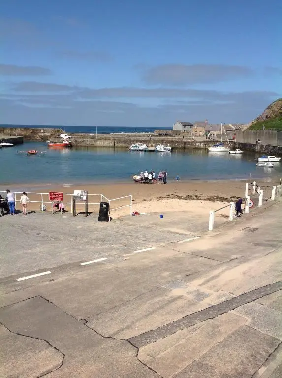 a group of people on a beach near a body of water at 244 Seatown Cullen Moray Scotland in Cullen