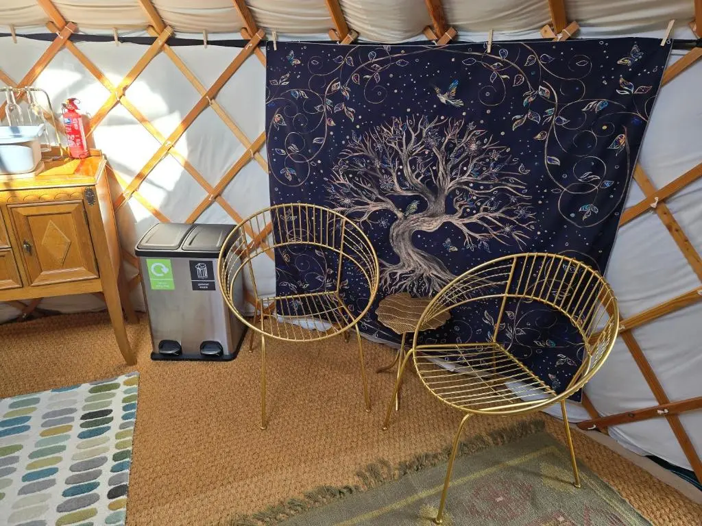 a couple of chairs and a pillow in a yurt at Rainbow's End Yurts in Dornoch