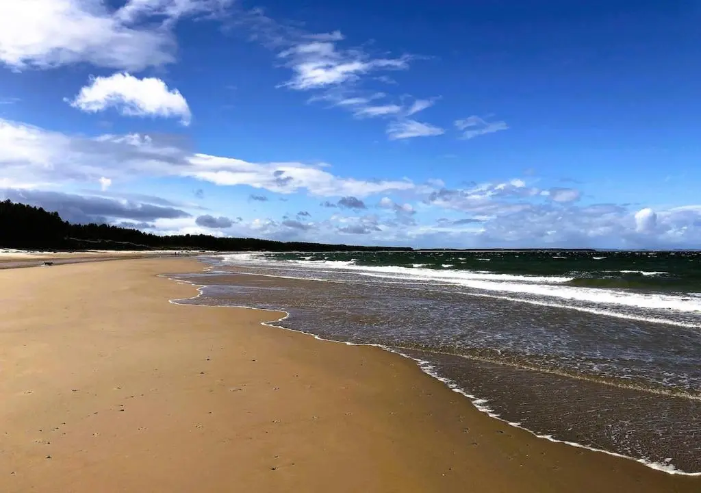 a beach with the ocean and the waves at Bespoke Luxury Self Catering Dog Friendly Accommodation in Archiestown