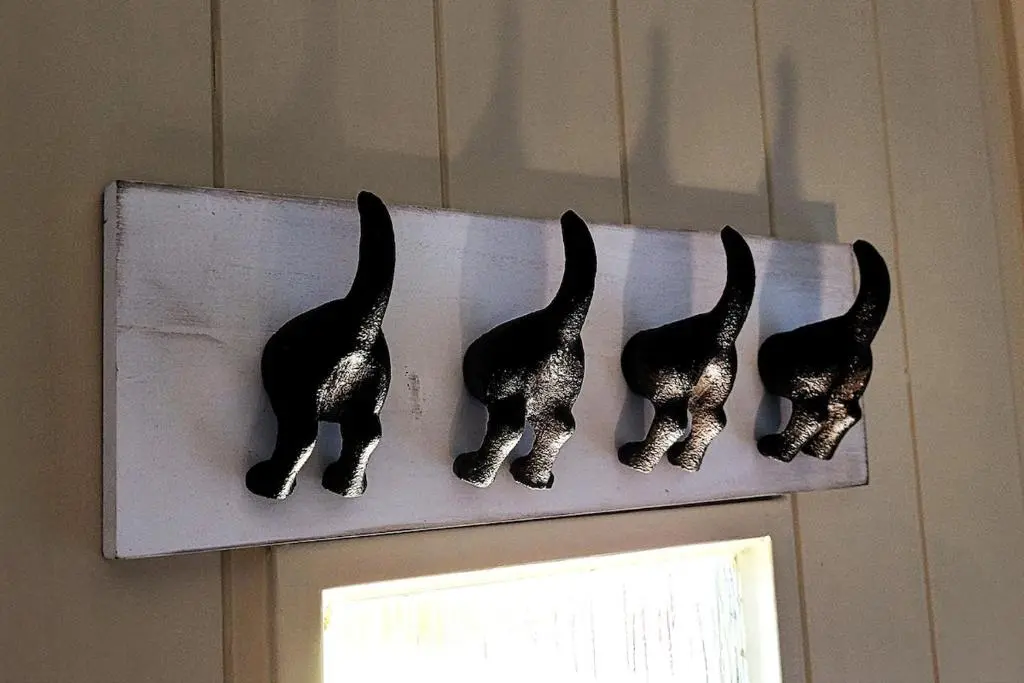 three black cats on a shelf above a door at Bespoke Luxury Self Catering Dog Friendly Accommodation in Archiestown