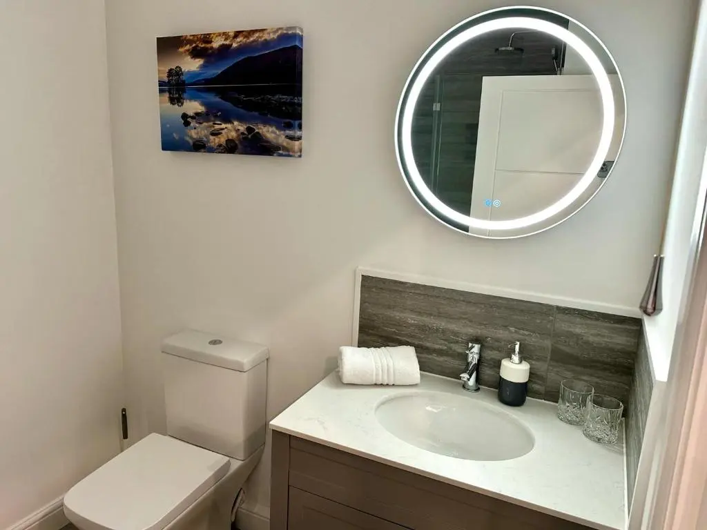 a bathroom with a sink and a mirror at Beechtree Cottage, Cairngorm Suite, Kirkmichael in Blairgowrie