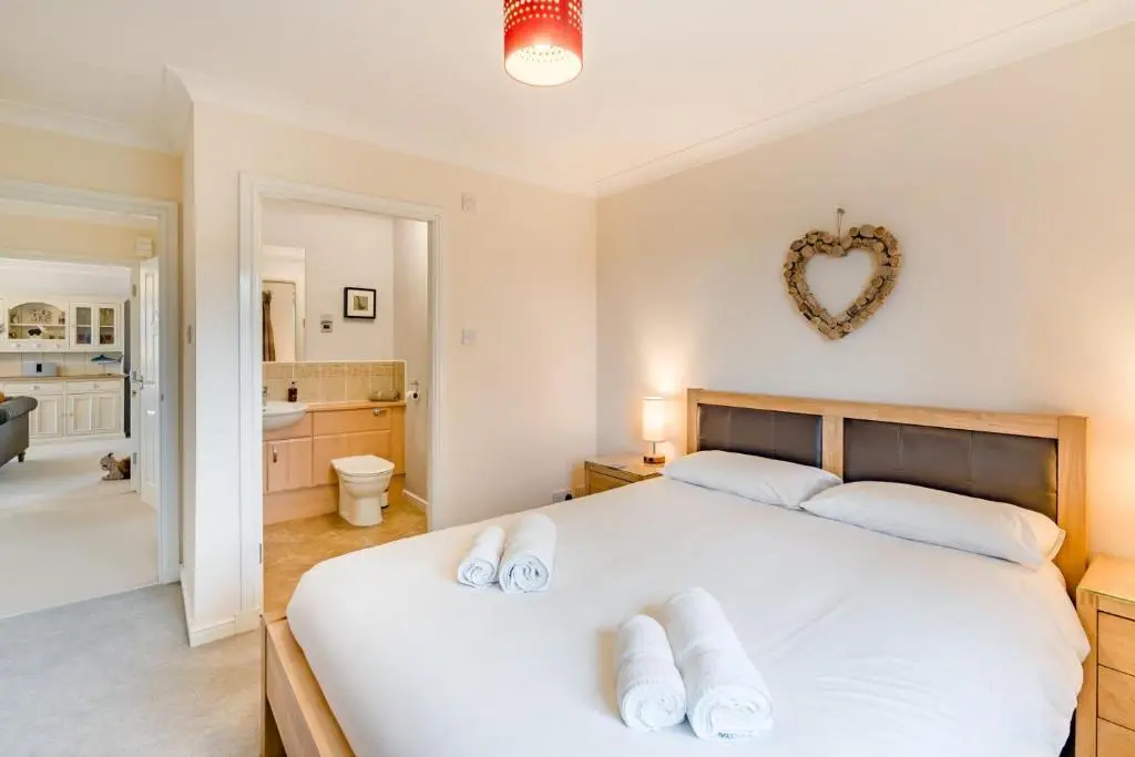 a bedroom with a large white bed with towels on it at 2 Bed in Aviemore oc-t30584 in Aviemore