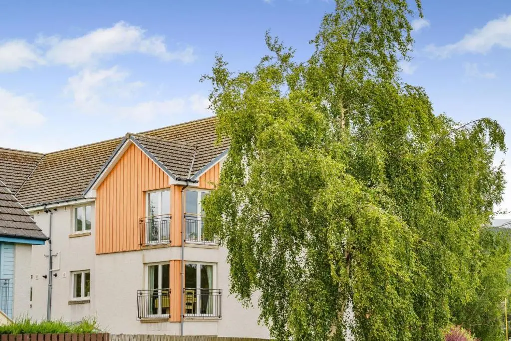 a house with a tree in front of it at 2 Bed in Aviemore oc-t30584 in Aviemore
