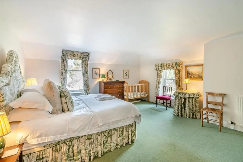 a bedroom with a large bed and a desk at 7 Bed in Strathdon oc-t30594 in Strathdon