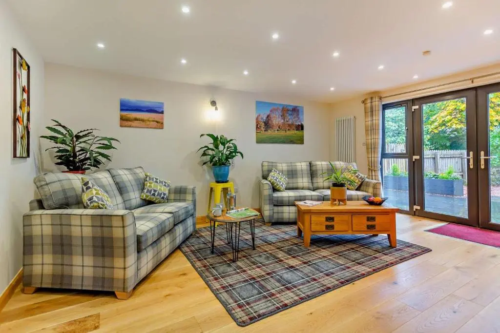 a living room with two couches and a coffee table at 1 Bed in Strathpeffer oc-h30077 in Strathpeffer