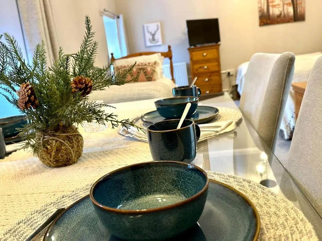 three bowls on a glass table in a living room at Beechtree Cottage, Ardle Family Room, Kirkmichael in Kirkmichael