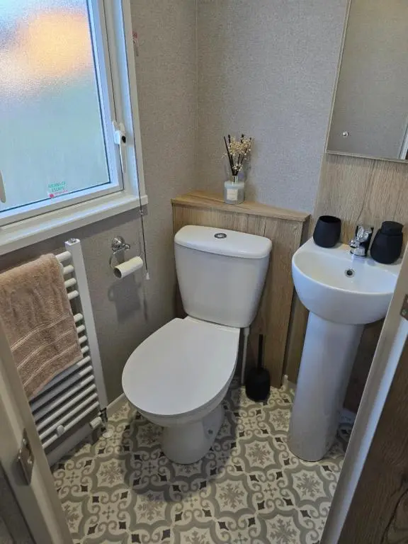 a bathroom with a white toilet and a sink at Clearwater View - Stunning sea views from large deck in Burghead