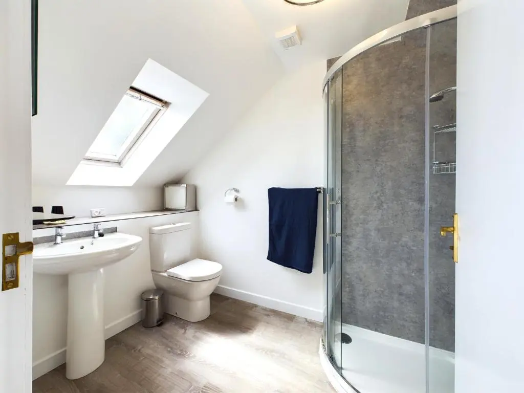 a bathroom with a sink toilet and a shower at Bright comfy home, sea views and big skies in Banff