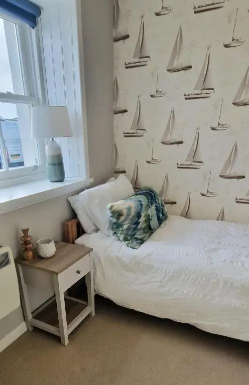 a bedroom with a bed with sails on the wall at North Coast Property - Avoch Beach House - Luxury house with sea views in Avoch