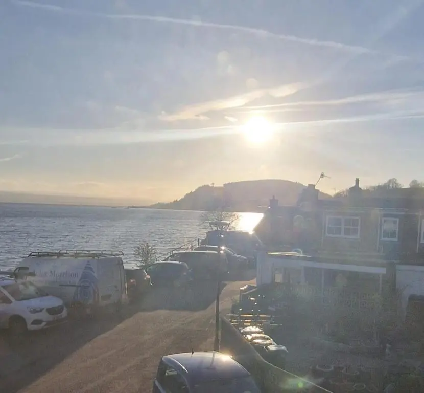 a group of cars parked next to a body of water at North Coast Property - Avoch Beach House - Luxury house with sea views in Avoch