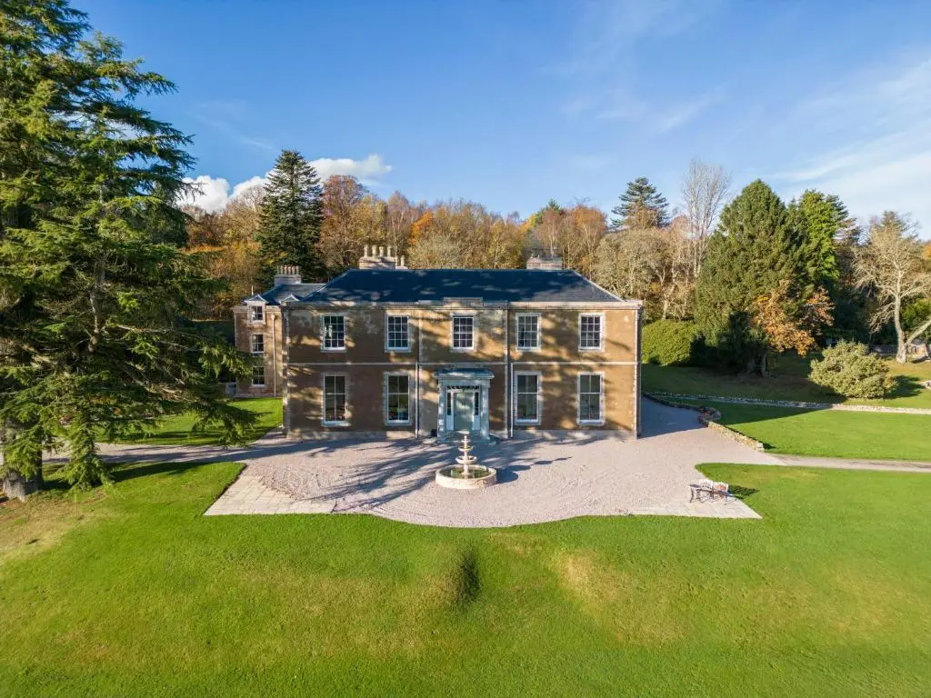 an image of a large house with a yard at Burnhervie House in Inverurie