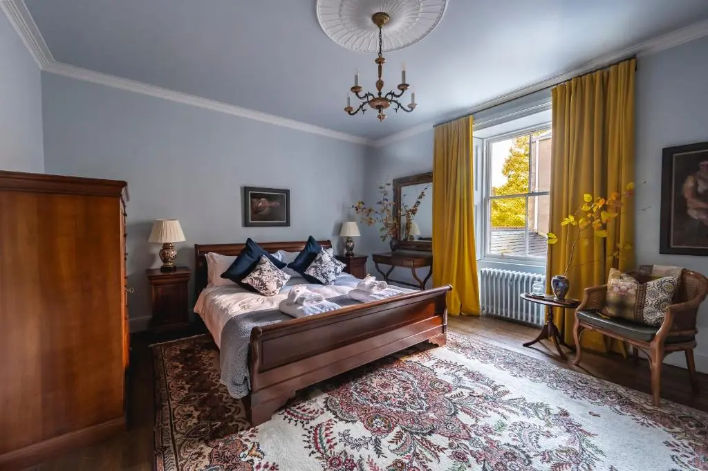a living room with a couch and a window at Burnhervie House in Inverurie