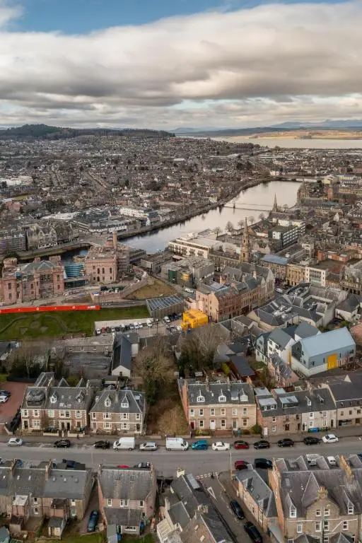 an aerial view of a city with a river at Ness Heights, Spacious City Centre Townhouse in Inverness