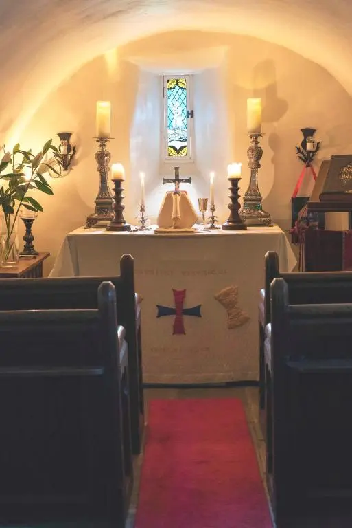 a altar in a church with two candles on it at Forter Castle in Blairgowrie
