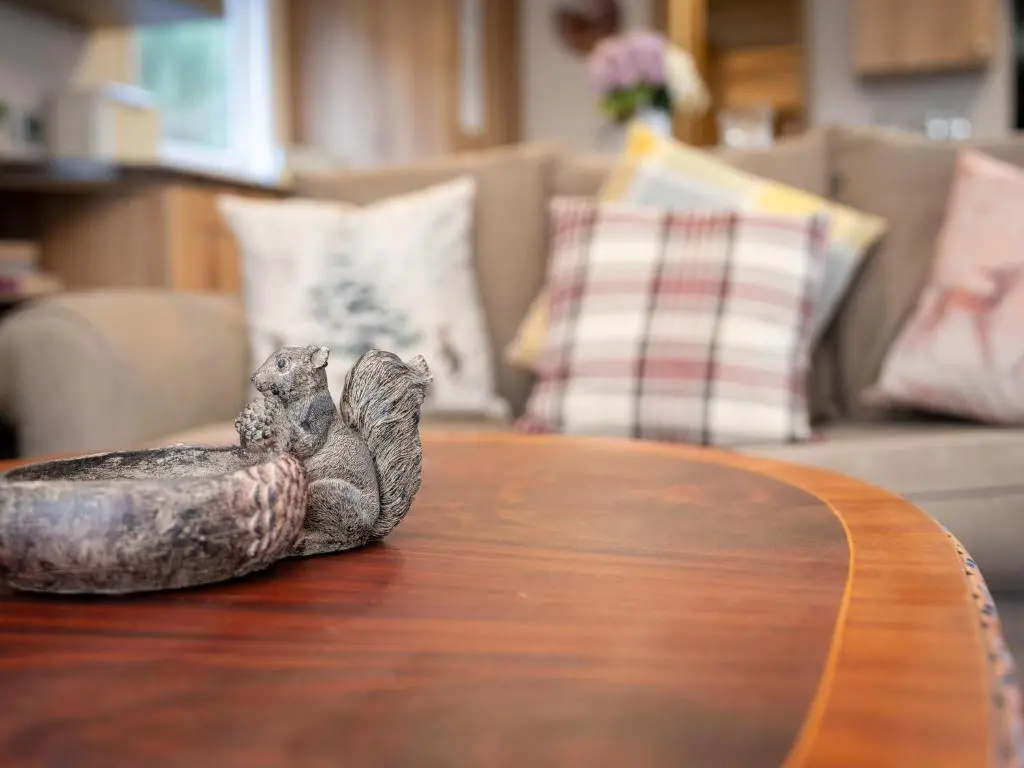 a statue of a snail sitting on top of a table at Chalet Cairn View by Interhome in Aviemore
