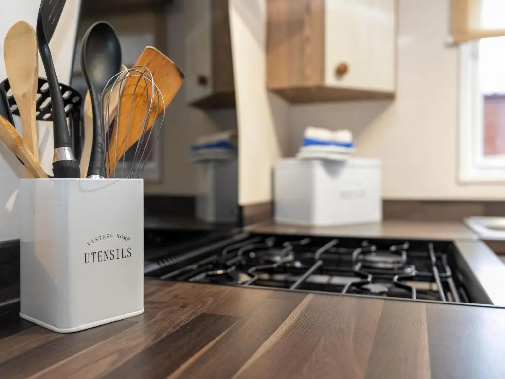 a container of kitchen utensils on a counter in a kitchen at Chalet Monarch by Interhome in Aviemore