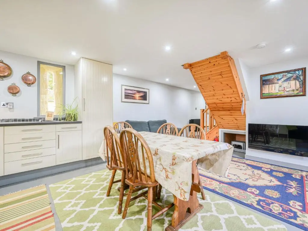 a kitchen and dining room with a table and chairs at Holiday Home Loch Ness Granary by Interhome in Invermoriston