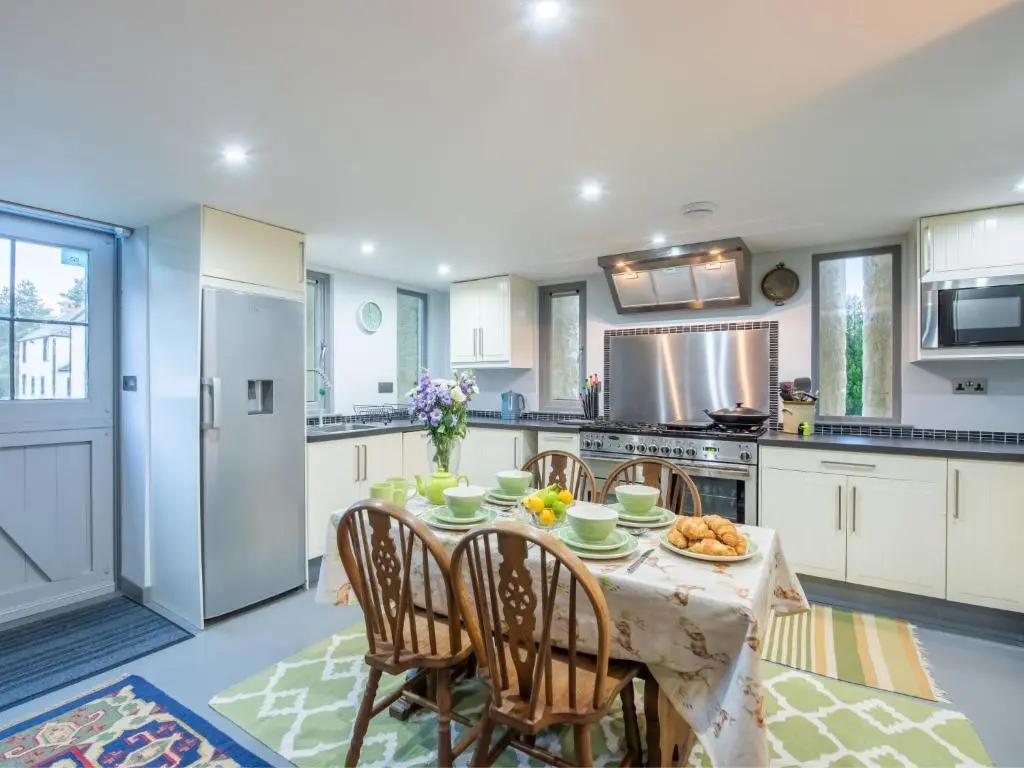 a kitchen with a table with food on it at Holiday Home Loch Ness Granary by Interhome in Invermoriston