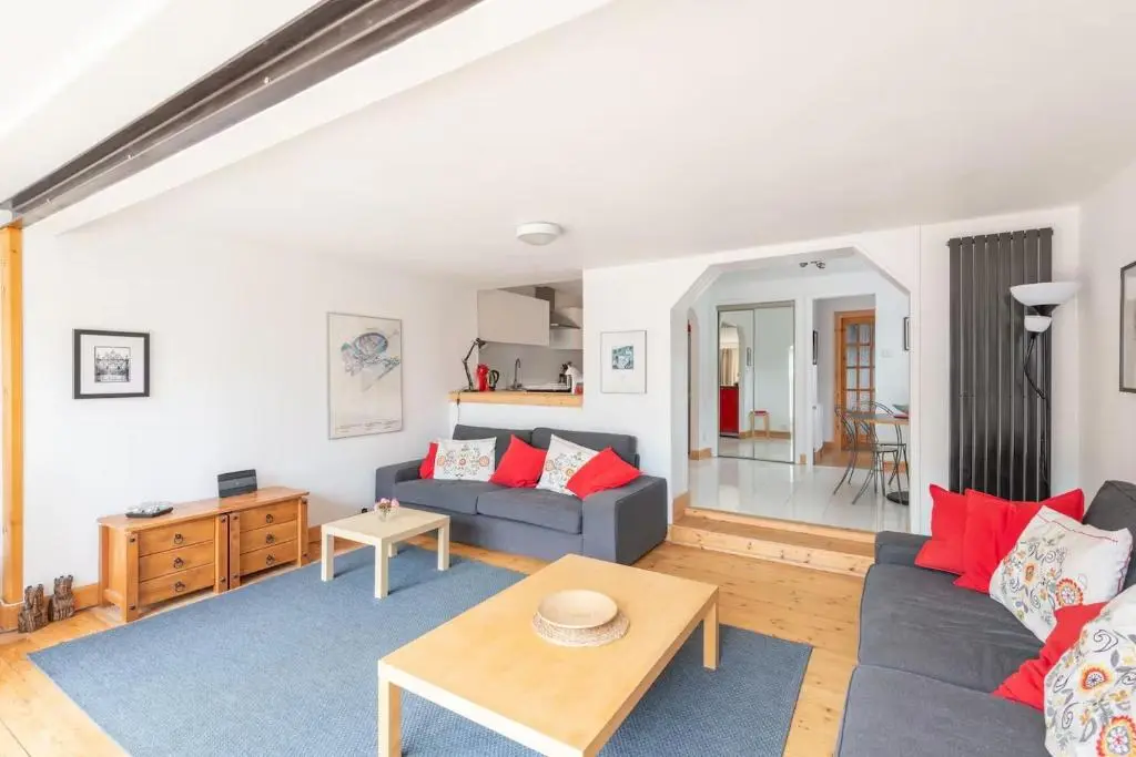 a living room with a couch and a table at 4guests-2br-privategarden-freeparking in Aviemore