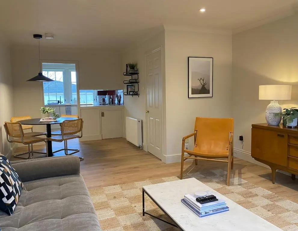 a living room with a couch and a table at Warm, stylish 2-bed in Crown, Inverness in Inverness