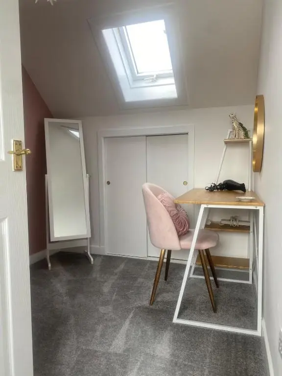 a room with a table and a chair and a skylight at Number Forty Two, Portsoy - A 3 bedroom cottage with sea views in Portsoy