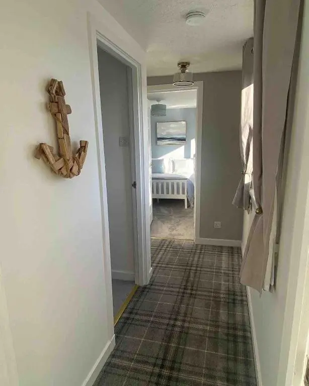 a hallway of a home with a door and a room at Number Forty Two, Portsoy - A 3 bedroom cottage with sea views in Portsoy