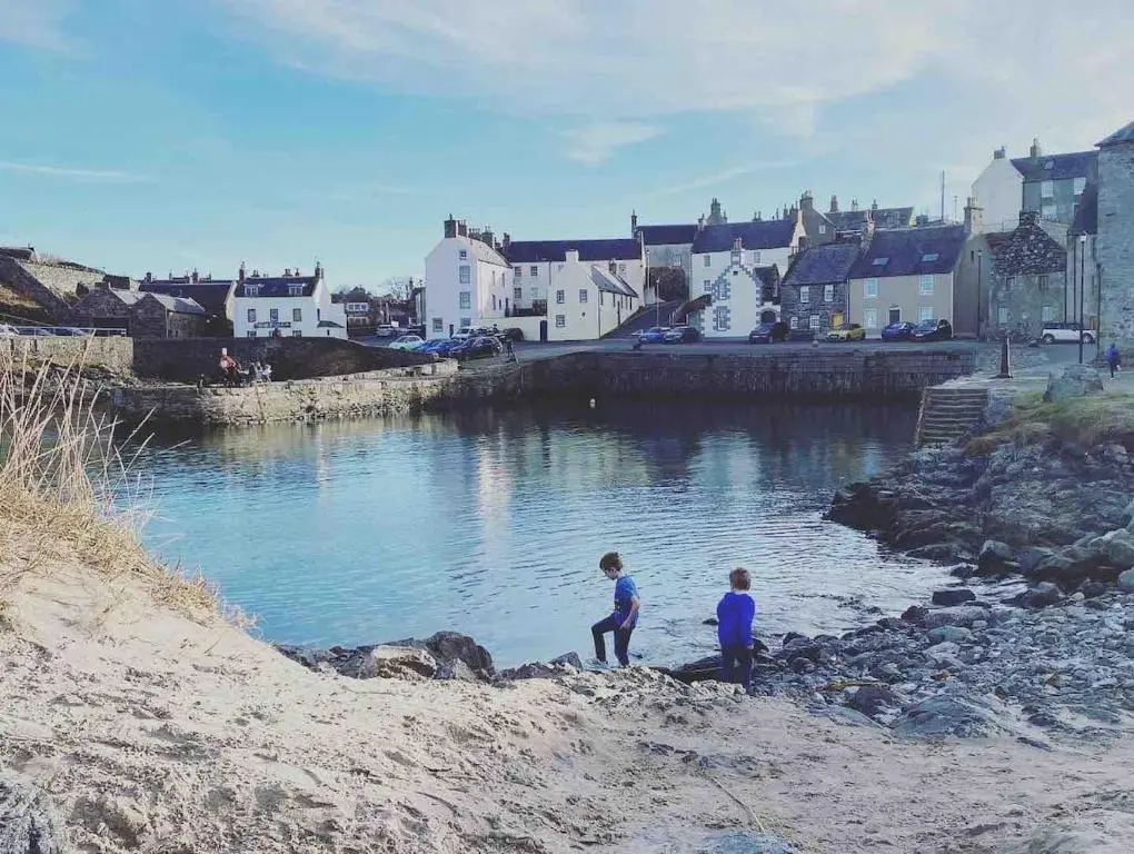 two children standing on the shore of a river at Number Forty Two, Portsoy - A 3 bedroom cottage with sea views in Portsoy