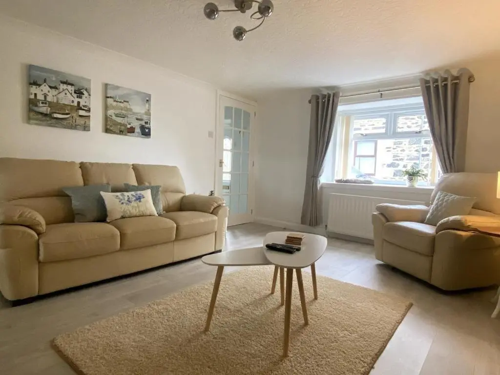 a living room with a couch and a table at Number Forty Two, Portsoy - A 3 bedroom cottage with sea views in Portsoy