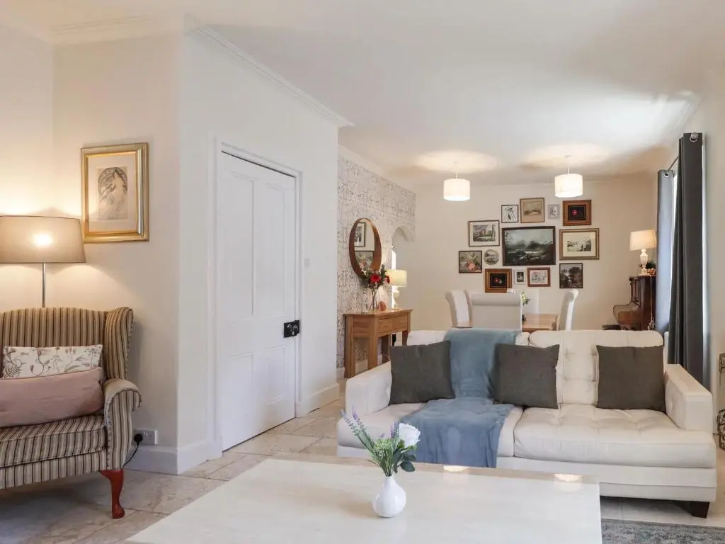 a living room with a couch and a table at Mary Ann Villa in Inverness