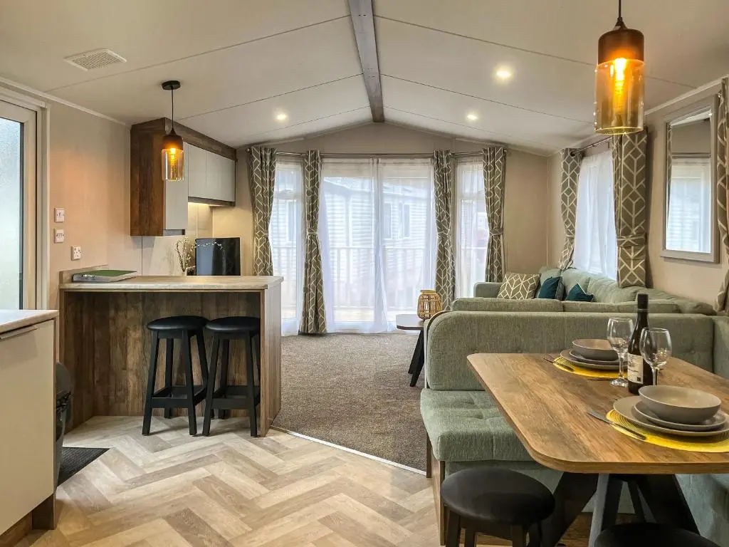 a kitchen and living room with a couch and a table at The Kestrel - Ukc6920 in Forres
