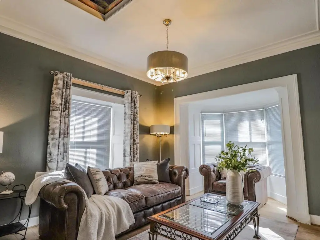 a living room with a couch and a table at Porter's Lodge in Inverness