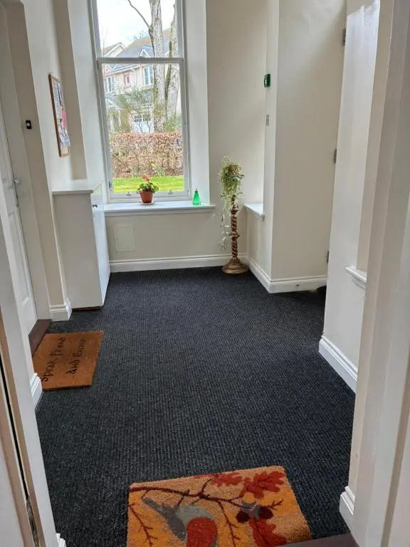 an empty hallway with a window and carpet at Junique Modern Ground Floor Apartment - 2 bedrooms in Aberdeen