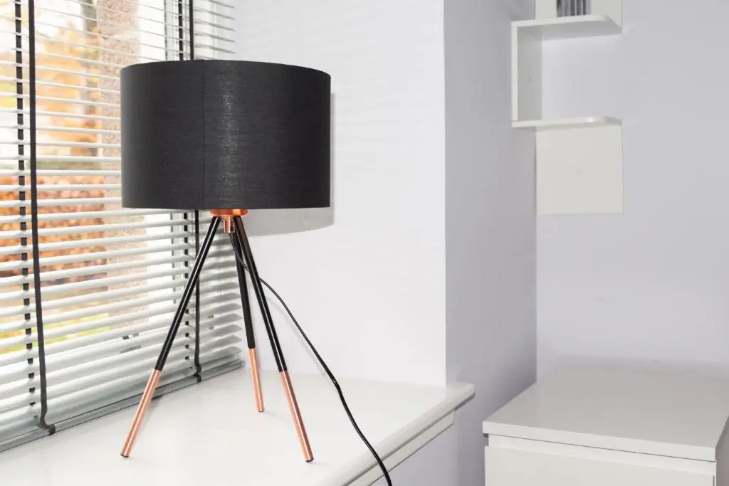 a black lamp sitting on a window sill at Junique Modern Ground Floor Apartment - 2 bedrooms in Aberdeen