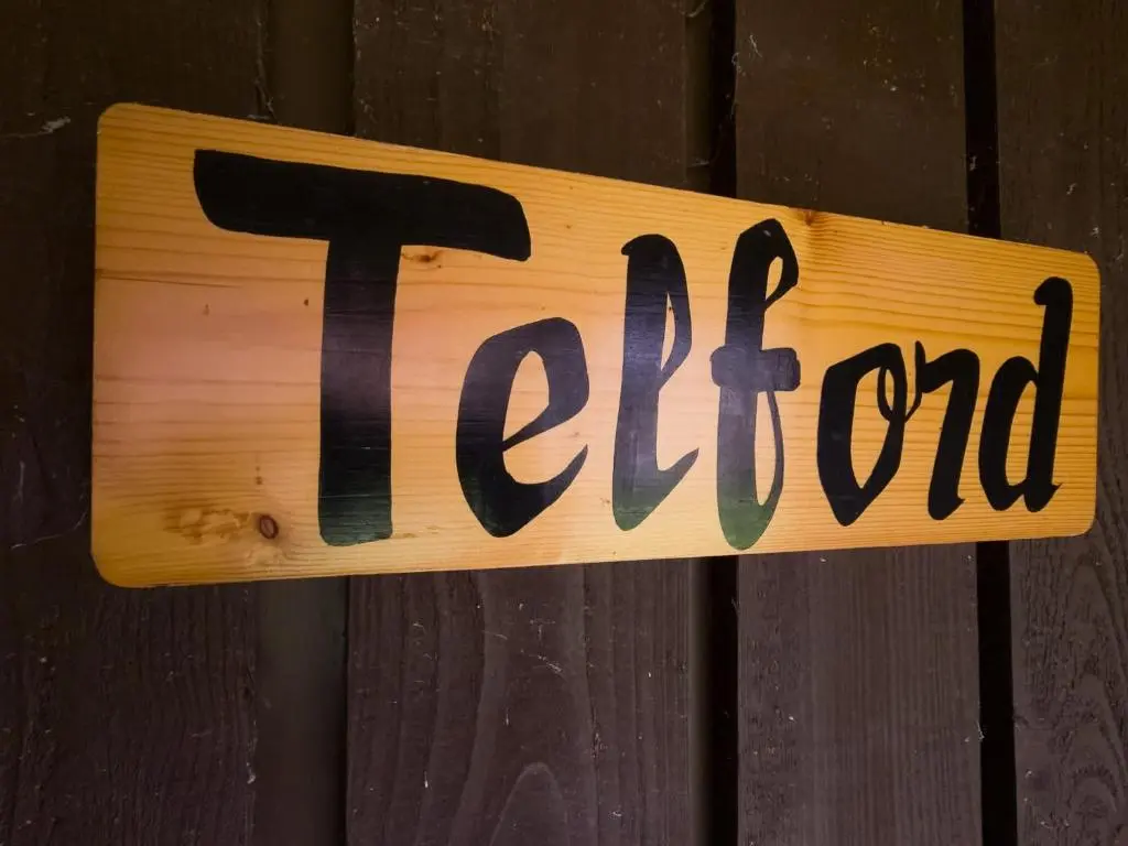 a sign on a wooden door with the word fire at Telford Cottage in Kincraig