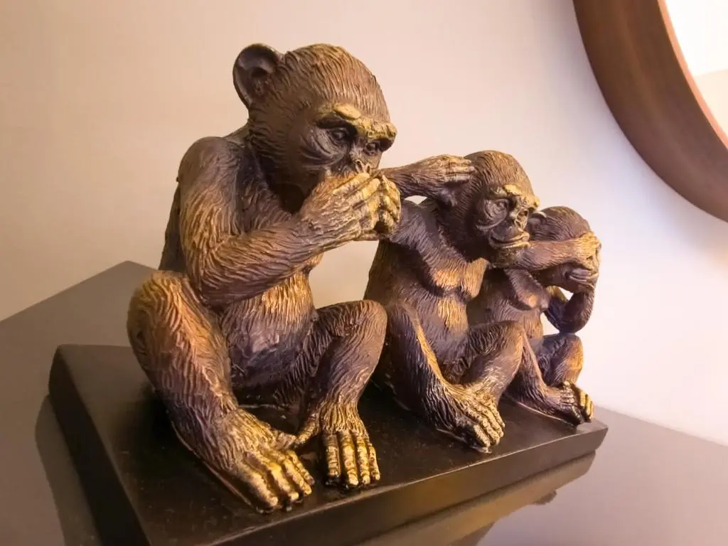 a statue of two chimpanzees sitting on a shelf at Fraser Cottage in Kincraig