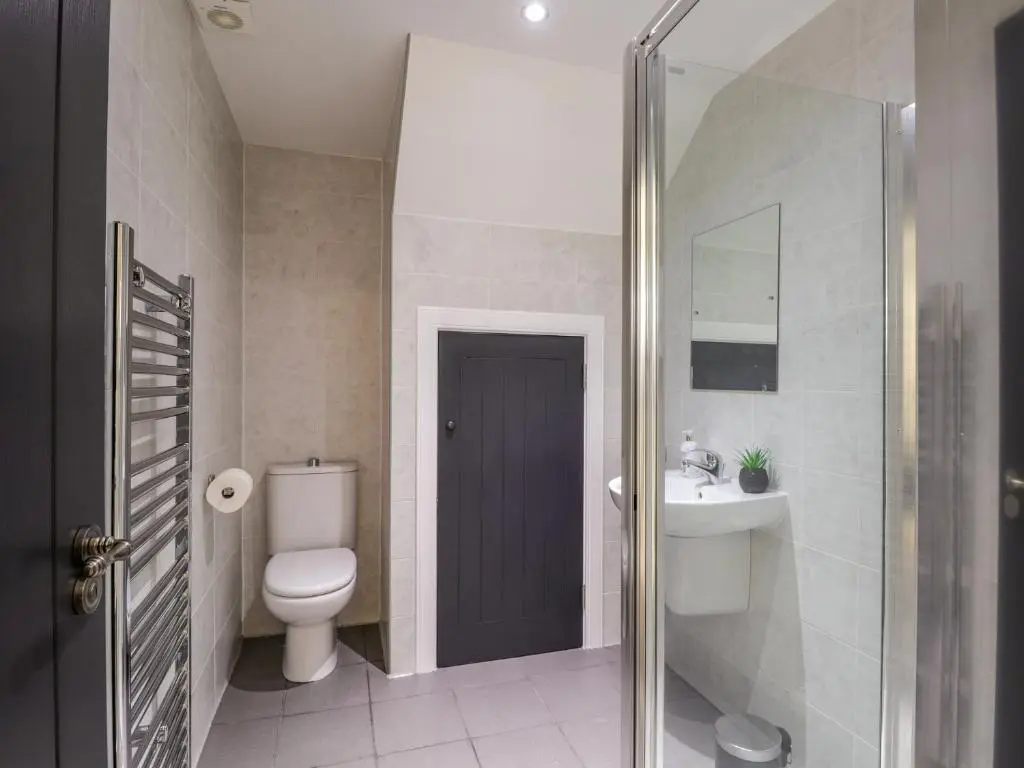 a bathroom with a toilet and a sink at 3 The Granary in Banff