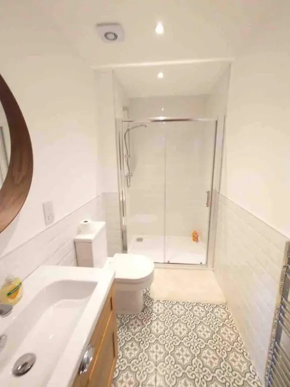 a bathroom with a shower and a toilet and a sink at River Retreat - Riverside Apartment in Inverness City Centre in Inverness
