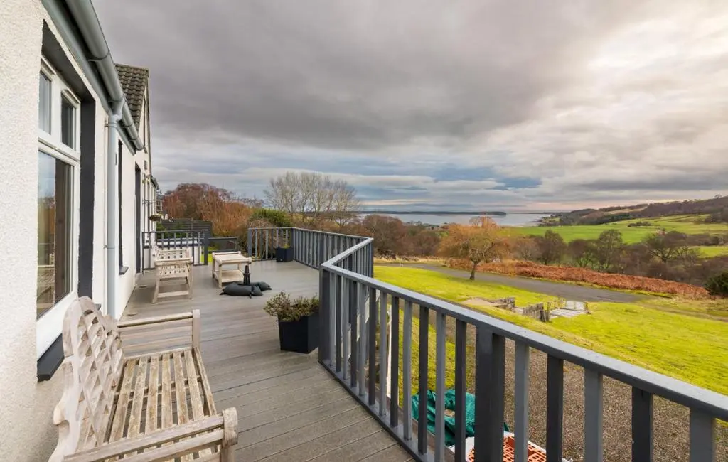 a balcony with benches and a view of a field at Strathview Lodge B&B in Dornoch