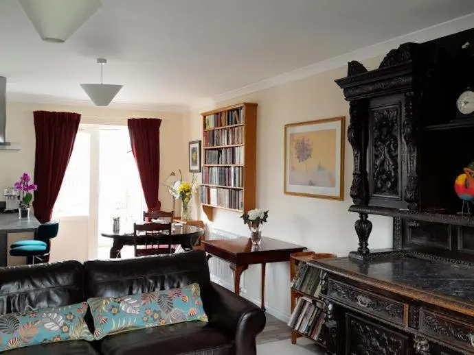 a living room with a couch and a dining room at No1Dornoch in Dornoch