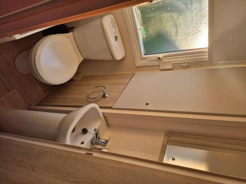 a small bathroom with a sink and a window at Badgers Den Silversands in Lossiemouth