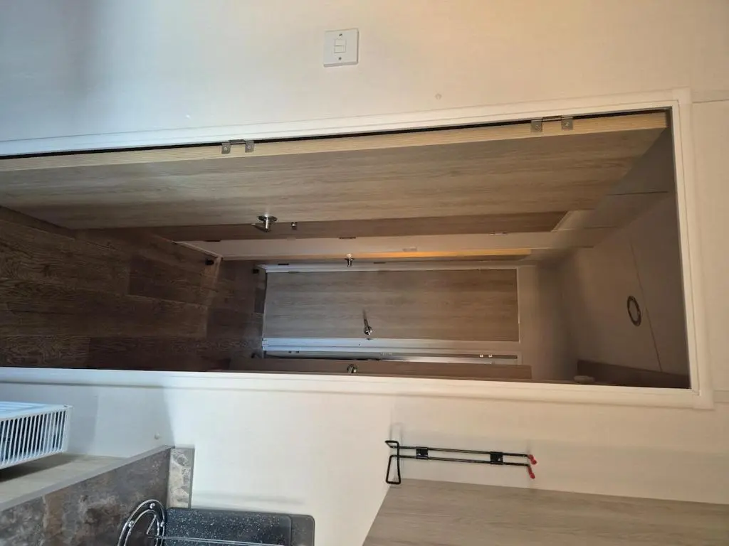 a kitchen with a large mirror on the wall at Badgers Den Silversands in Lossiemouth