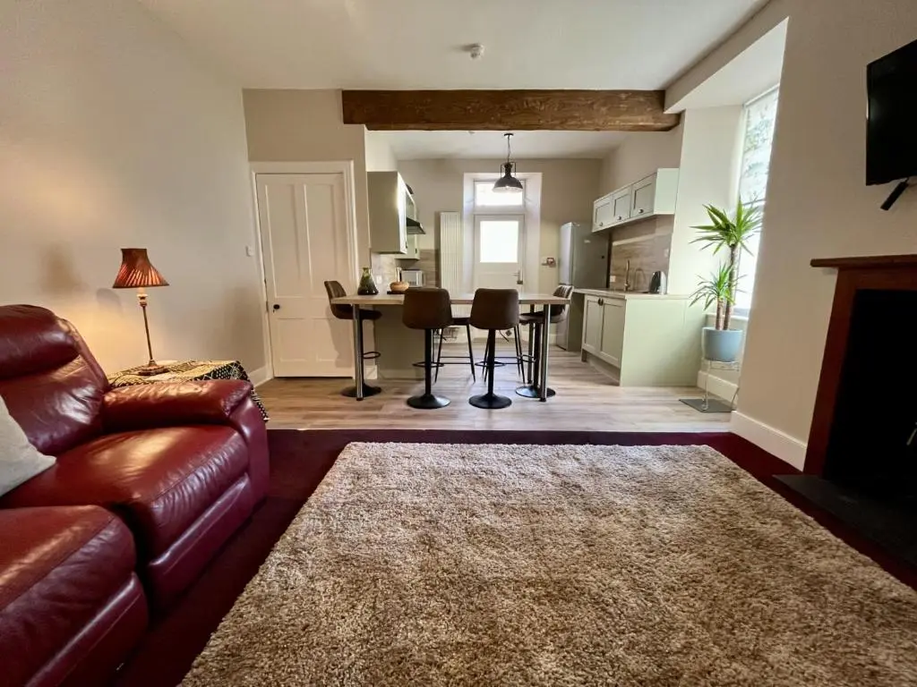a living room with a couch and a table at The Farmhouse Snug in Spean Bridge