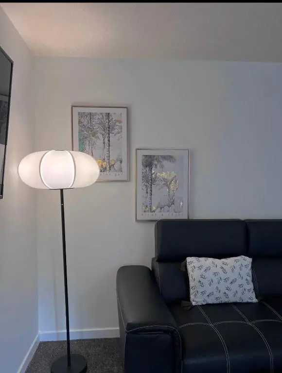a living room with a blue couch and a lamp at Charming City Centre Flat in Inverness