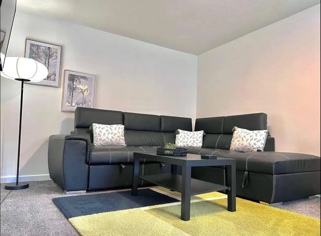 a living room with a couch and a table at Charming City Centre Flat in Inverness