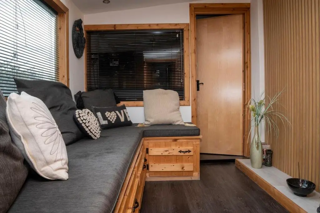 a couch in a living room with a window at Den of Allachlade in Aboyne