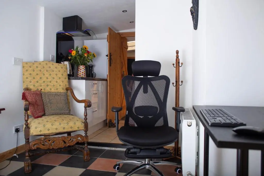 a room with a desk and a chair and a computer at Den of Allachlade in Aboyne