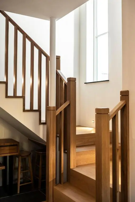 a staircase in a house with a window at Holly Tree Cottage in Dornoch